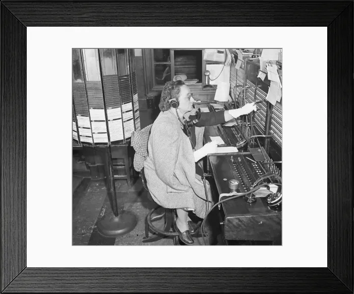 Framed Print : Hotel Switchboard Operator in Coat and Gloves
