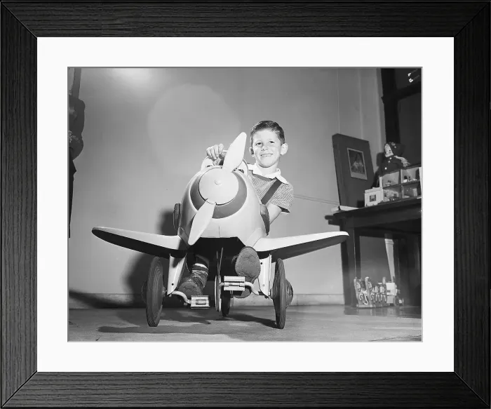 Framed Print : Boy Riding Plane Shaped Tricycle Framed Print : Boy Riding Plane Shaped Tricycle