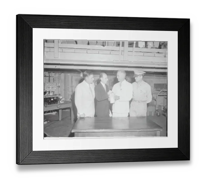 Framed Print : Doctor Presenting Container of Isotopes