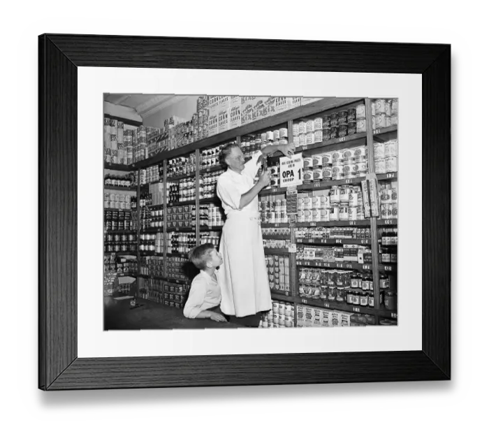 Framed Print : Store Owner Putting Sign Up In Grocery Framed Print : Store Owner Putting Sign Up In Grocery