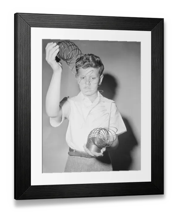 Framed Print : Boy Playing With Slinky Toy
