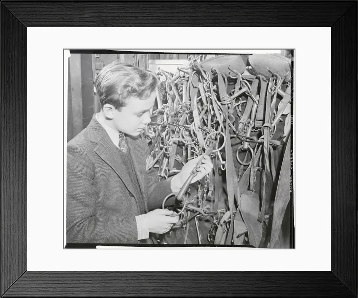 Framed Print : Ben Cooper Examining Bit in Equestrian Shop Framed Print : Ben Cooper Examining Bit in Equestrian Shop