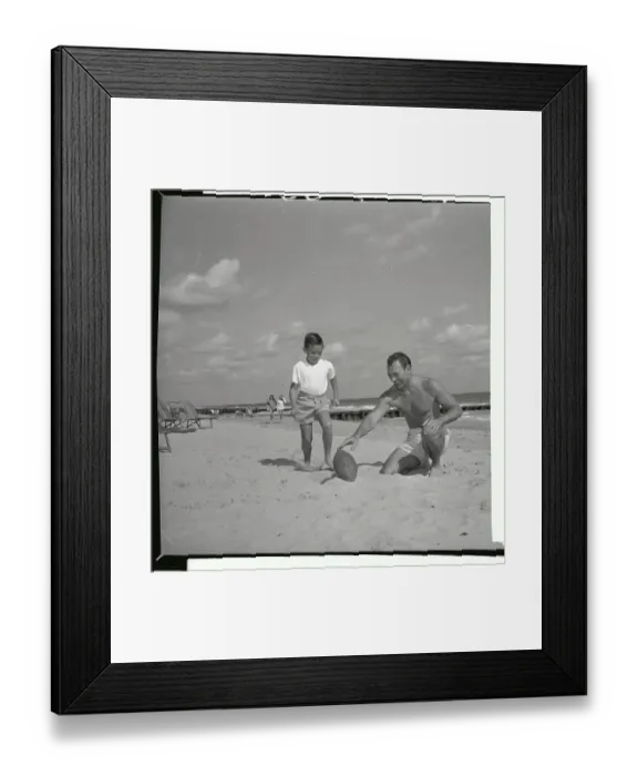 Framed Print : Herschel Martin Holding Football for Young Boy Framed Print : Herschel Martin Holding Football for Young Boy