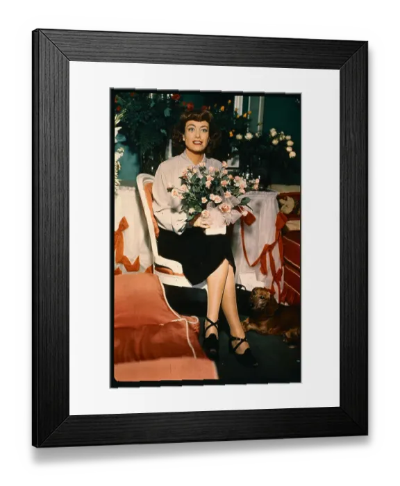 Framed Print : Joan Crawford Sitting with Dog and Flowers Framed Print : Joan Crawford Sitting with Dog and Flowers