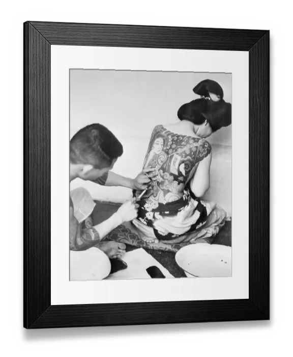 Framed Print : Artist Tattooing The Back Of A Woman Framed Print : Artist Tattooing The Back Of A Woman