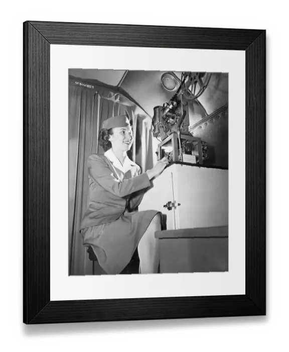 Framed Print : Stewardess Showing Talking Movie on Flight Framed Print : Stewardess Showing Talking Movie on Flight