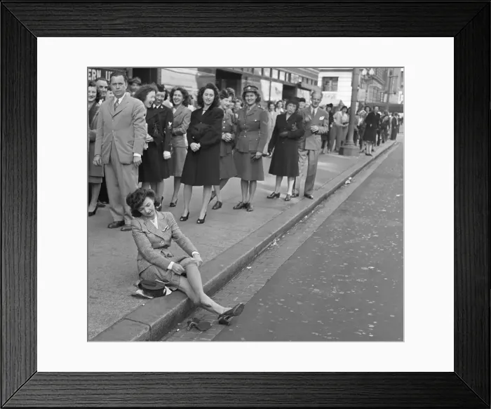 Framed Print : Woman Trying on a Pair of Nylons on Sidewalk Framed Print : Woman Trying on a Pair of Nylons on Sidewalk