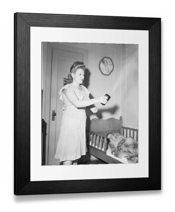 Framed Print : Woman Sprays DDT Over Her Child Framed Print : Woman Sprays DDT Over Her Child