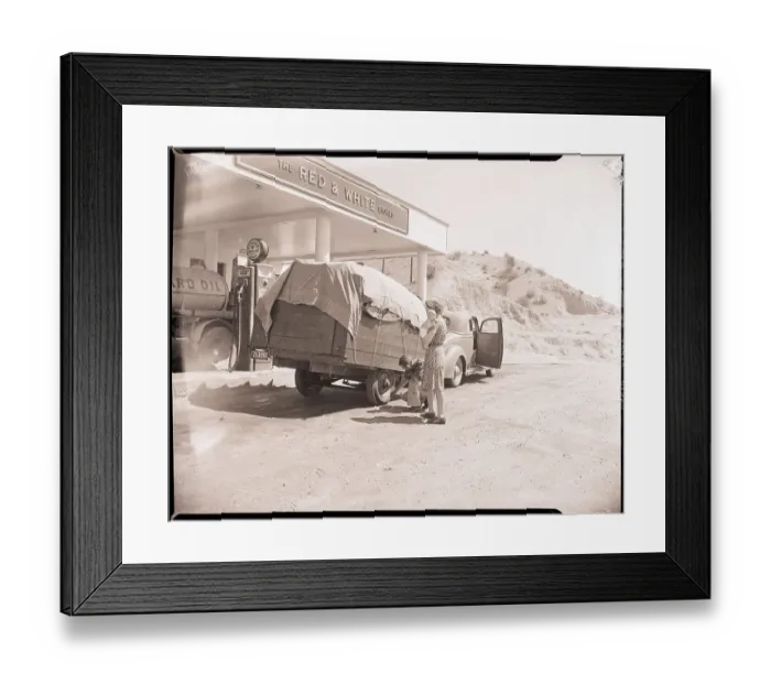 Framed Print : Man Checks Trailer Tires at Gas Station Framed Print : Man Checks Trailer Tires at Gas Station