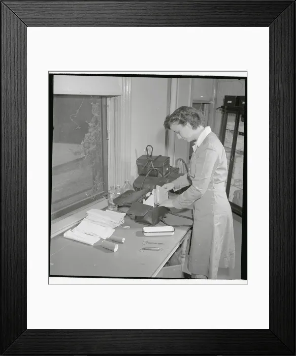 Framed Print : Nurse Checking Contents of Her Bag Framed Print : Nurse Checking Contents of Her Bag