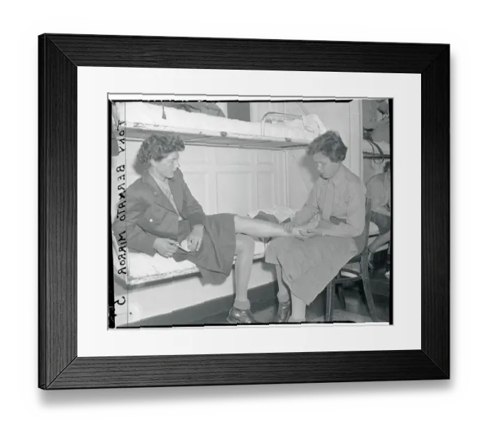 Framed Print : Woman Checking a Person's Sprained Ankle Framed Print : Woman Checking a Person's Sprained Ankle