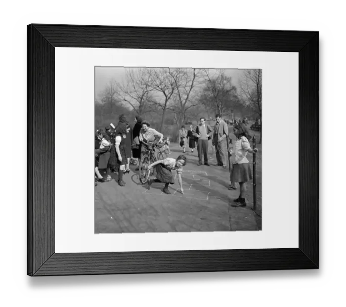 Framed Print : USA, New York City, Manhattan, Central Park, Girls (8-9) playing hop scotch Framed Print : USA, New York City, Manhattan, Central Park, Girls (8-9) playing hop scotch