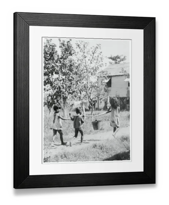 Framed Print : Children Carrying Pail of Water Framed Print : Children Carrying Pail of Water