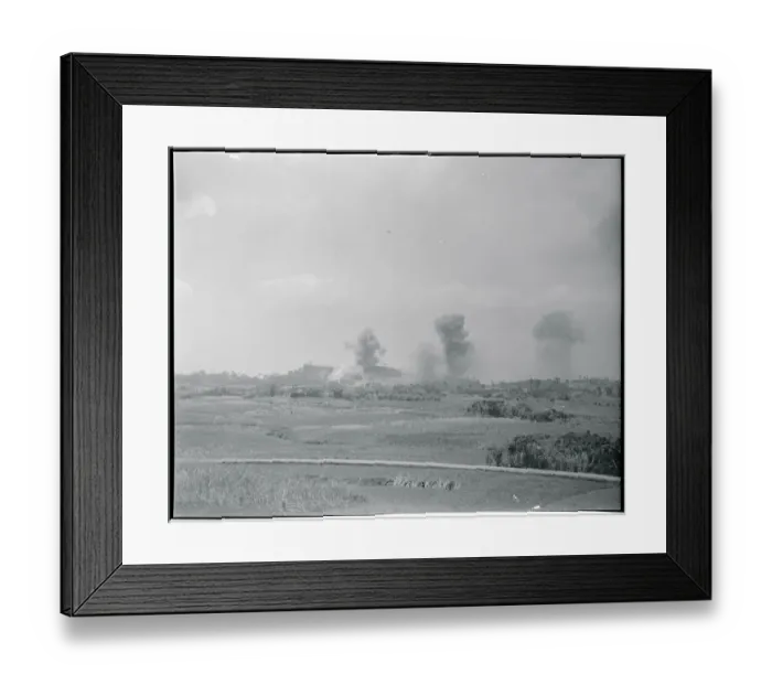 Framed Print : Distant View of Smoking Land Areas Under Bomb Attack