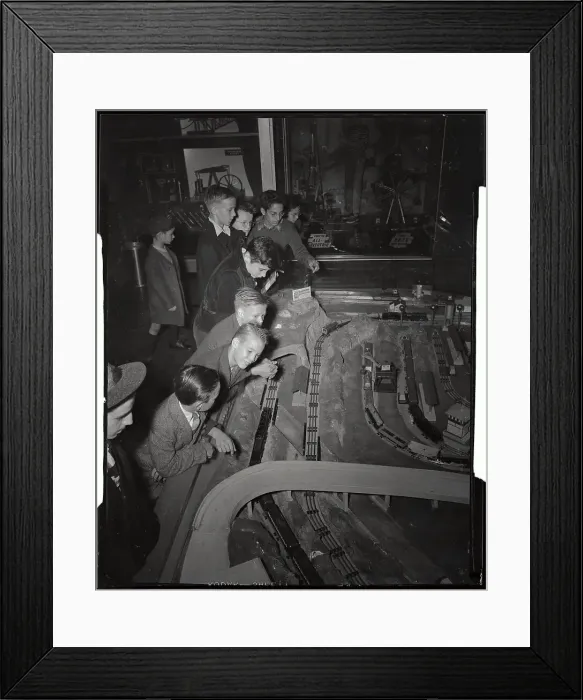 Framed Print : Youngsters Observing Electric Train Set Framed Print : Youngsters Observing Electric Train Set