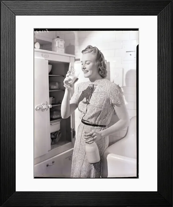 Framed Print : Woman Drinking Milk Next to the Refrigerator Framed Print : Woman Drinking Milk Next to the Refrigerator