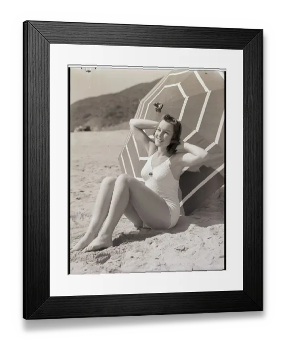 Framed Print : Sunbather Leaning Against Umbrella Framed Print : Sunbather Leaning Against Umbrella