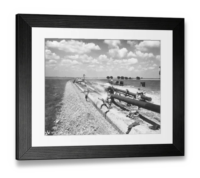 Framed Print : Man Leaps Over Trench Before Pipe Put In Framed Print : Man Leaps Over Trench Before Pipe Put In