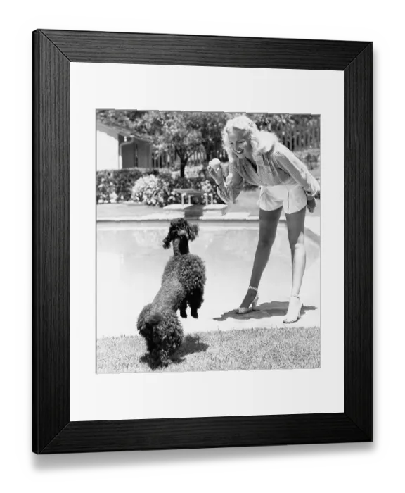 Framed Print : Betty Grable Playing with Her Poodle Framed Print : Betty Grable Playing with Her Poodle