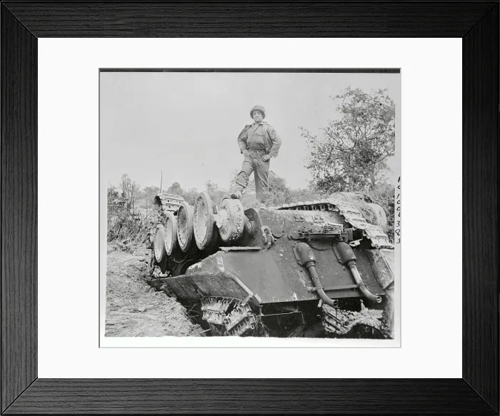 Framed Print : US Soldier Standing Atop Overturned Tank