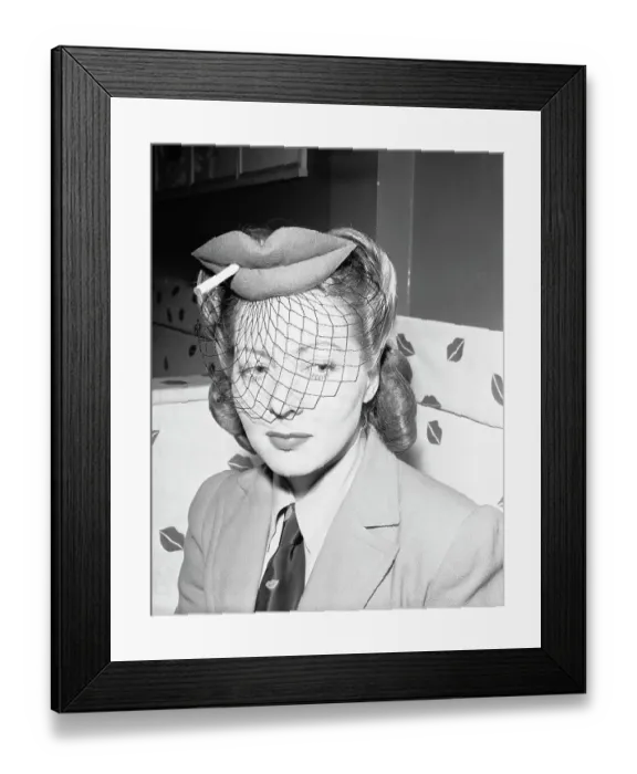 Framed Print : Actress Wearing Hat in Shape of Lips with Cigarette and Veil Framed Print : Actress Wearing Hat in Shape of Lips with Cigarette and Veil