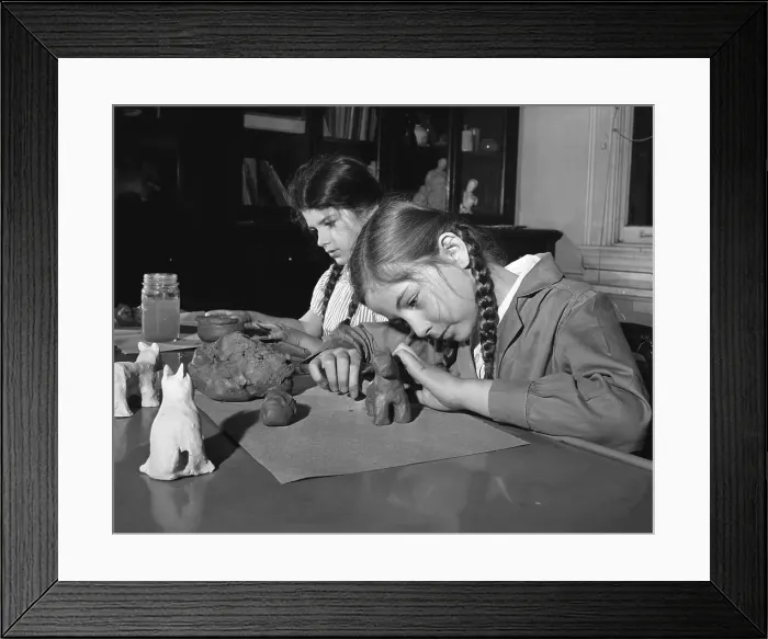 Framed Print : Pre-teen girls (10-12) working with plasticize