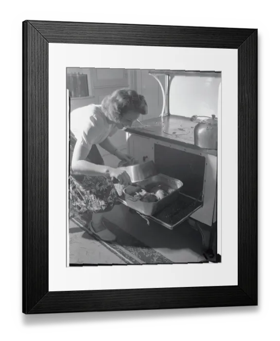 Framed Print : Housewife Checking on Chicken in Oven Framed Print : Housewife Checking on Chicken in Oven