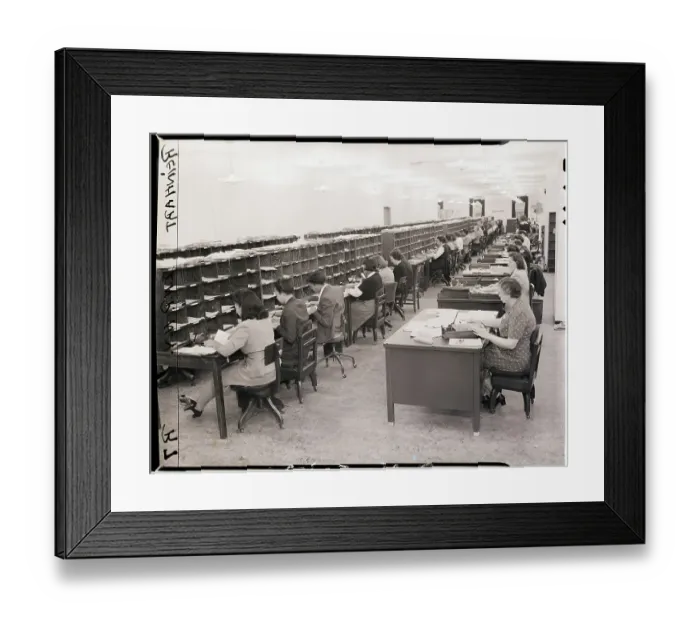 Framed Print : Seated Clerks Look Through and Sort Mail Framed Print : Seated Clerks Look Through and Sort Mail