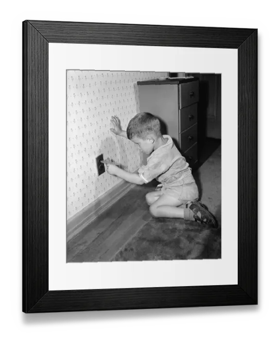 Framed Print : Boy Putting Toy into an Outlet Framed Print : Boy Putting Toy into an Outlet