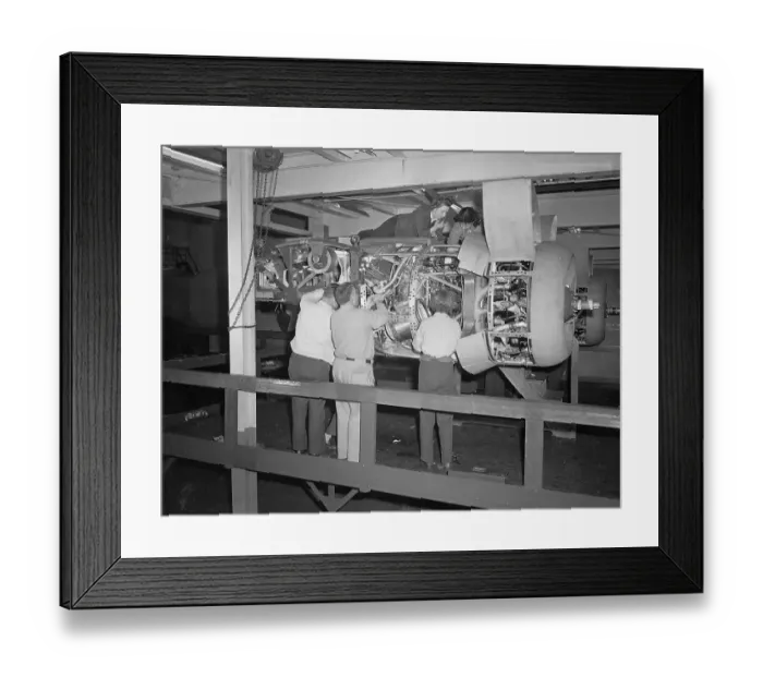Framed Print : Workmen Fitting a Motor into a Bomber Plane Framed Print : Workmen Fitting a Motor into a Bomber Plane