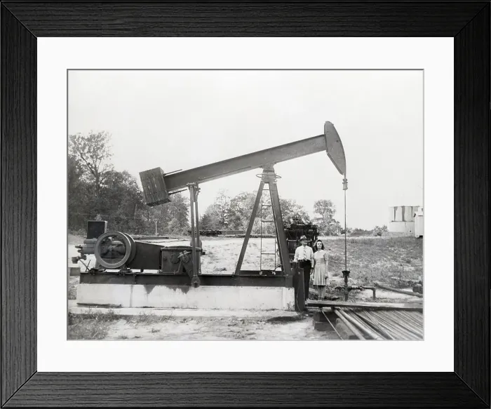 Framed Print : Man & Daughter Stand Under Old Oil Drill Framed Print : Man & Daughter Stand Under Old Oil Drill