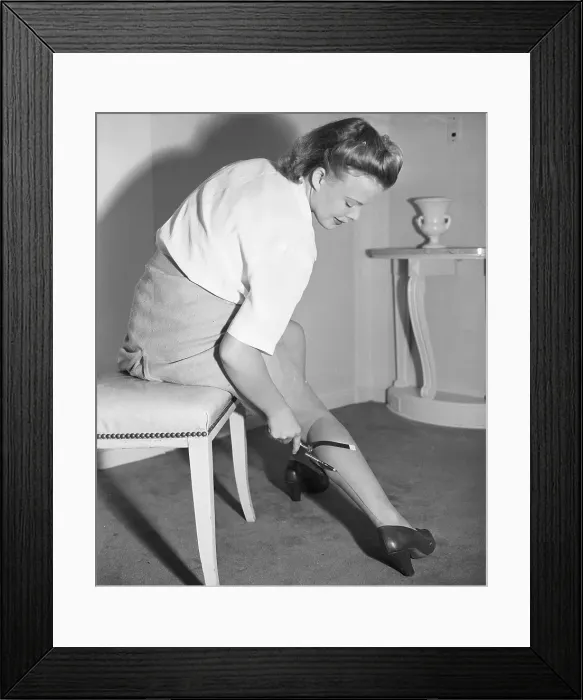Framed Print : Woman Drawing False Stockings on Her Leg Framed Print : Woman Drawing False Stockings on Her Leg
