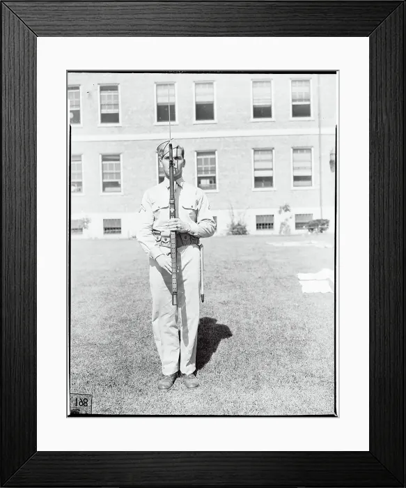 Framed Print : Soldier Holding Weapon in Front of his Body
