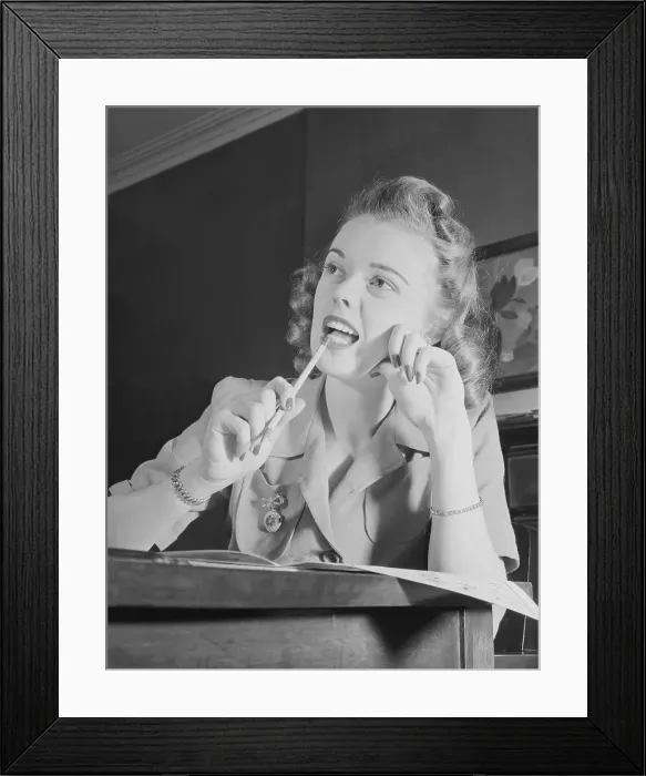 Framed Print : Young Female Student Biting on a Pencil Framed Print : Young Female Student Biting on a Pencil