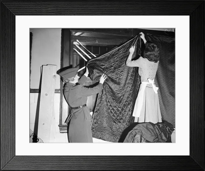 Framed Print : Women Blacking Out Windows With Blanket