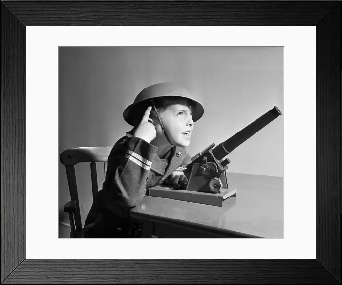 Framed Print : Boy with Helmet Operating Toy Missile Gun Framed Print : Boy with Helmet Operating Toy Missile Gun