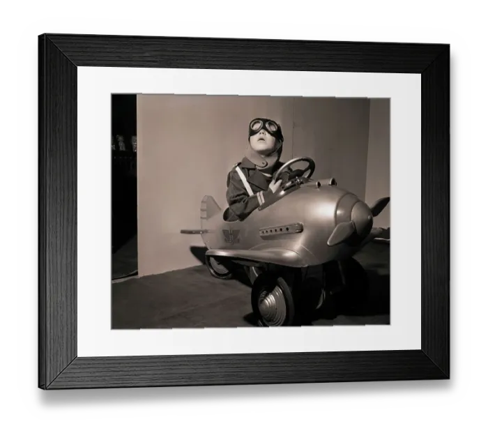 Framed Print : Boy in Aviator Suit Sitting in Toy Plane Framed Print : Boy in Aviator Suit Sitting in Toy Plane