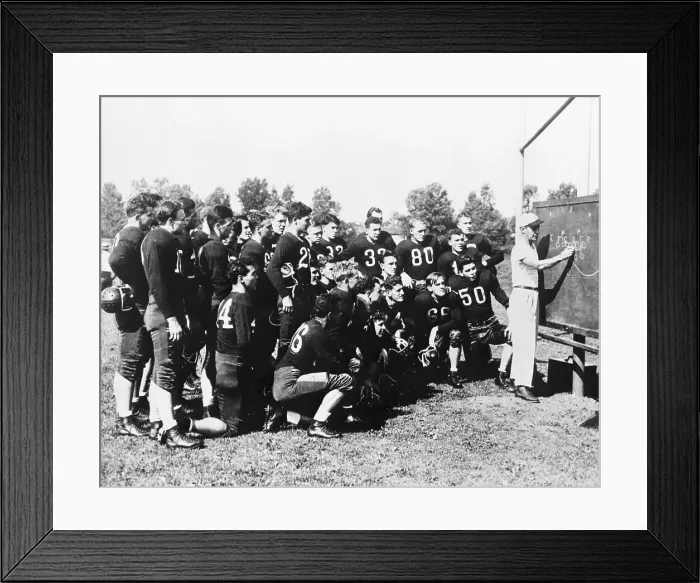 Framed Print : Coach Showing Football Play Framed Print : Coach Showing Football Play