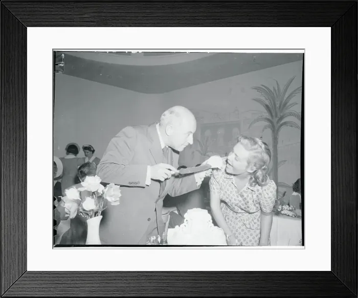 Framed Print : Cecil B. Demille Feeding Cake to Madeleine Carroll Framed Print : Cecil B. Demille Feeding Cake to Madeleine Carroll