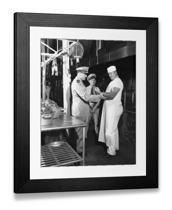 Framed Print : Gene Tunney Inspects Tattoos on Cooks Arm Framed Print : Gene Tunney Inspects Tattoos on Cooks Arm