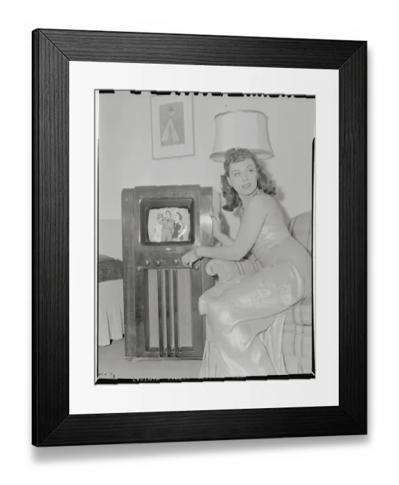Framed Print : Young Woman Sitting Next to Television Framed Print : Young Woman Sitting Next to Television