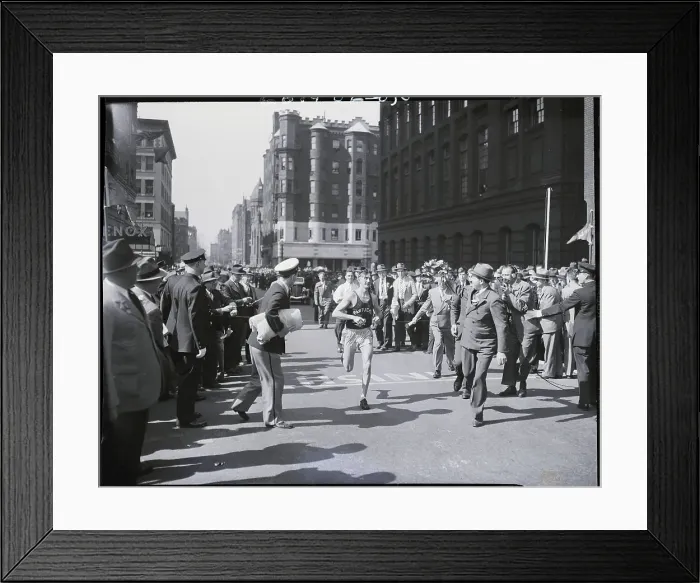 Framed Print : Man Crossing Finish In Marathon