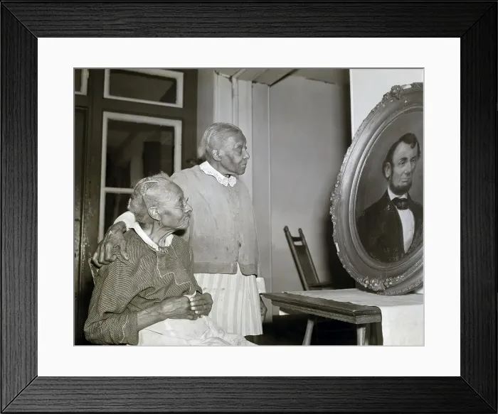 Framed Print : Two Elderly Black Women Look At Portrait Framed Print : Two Elderly Black Women Look At Portrait