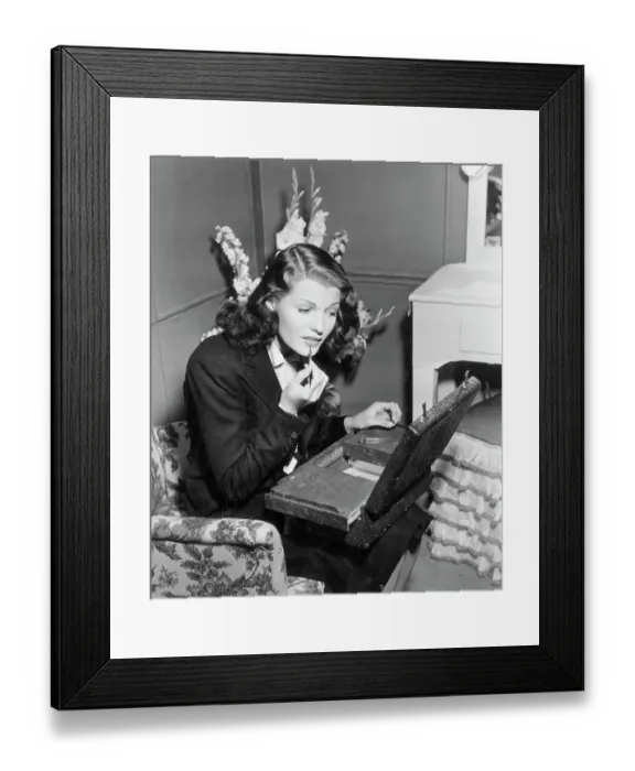 Framed Print : Hayworth Applies Lipstick W / Case On Knee Framed Print : Hayworth Applies Lipstick W / Case On Knee