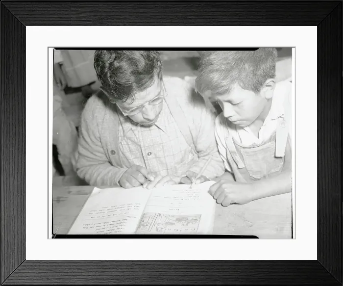Framed Print : Mexican Parent and Son Reading from Book Framed Print : Mexican Parent and Son Reading from Book