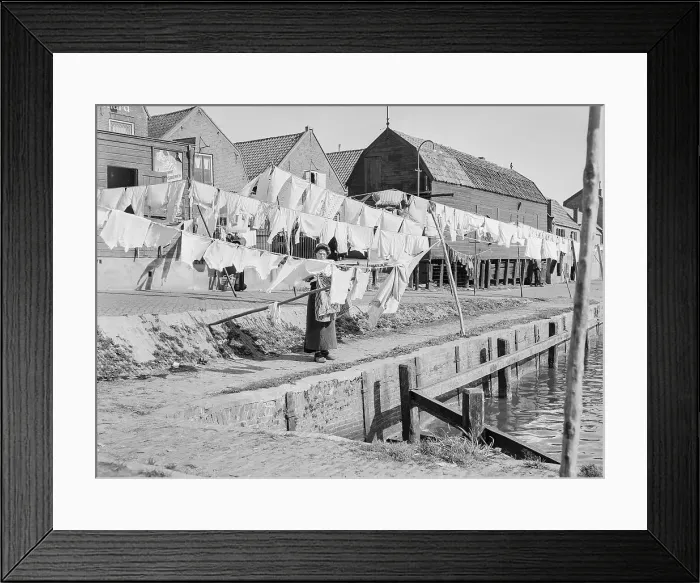Framed Print : Woman Hanging Clothes to Dry on Docks Framed Print : Woman Hanging Clothes to Dry on Docks