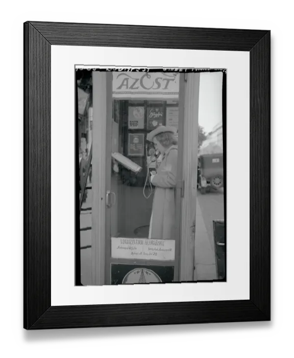 Framed Print : Young Woman Using Public Telephone Framed Print : Young Woman Using Public Telephone