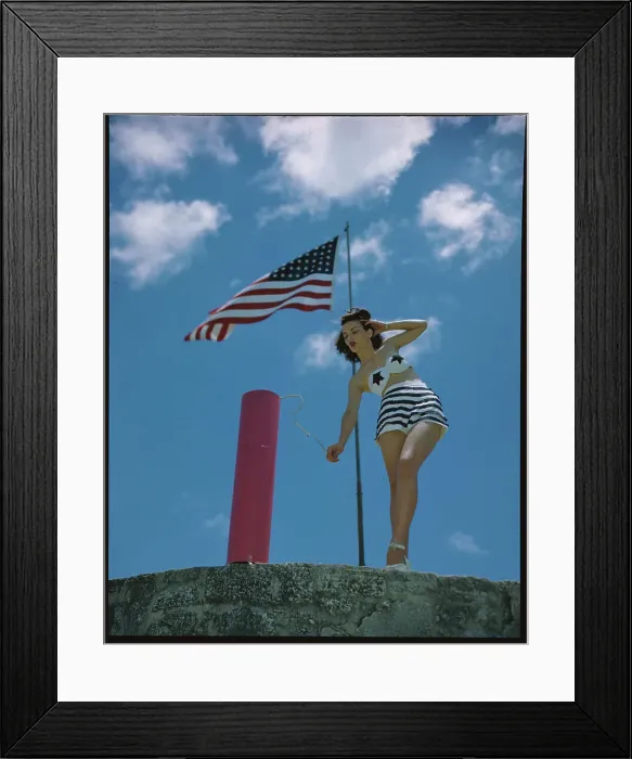 Framed Print : Young Woman in Bathing Suit Lighting Firecracker Framed Print : Young Woman in Bathing Suit Lighting Firecracker