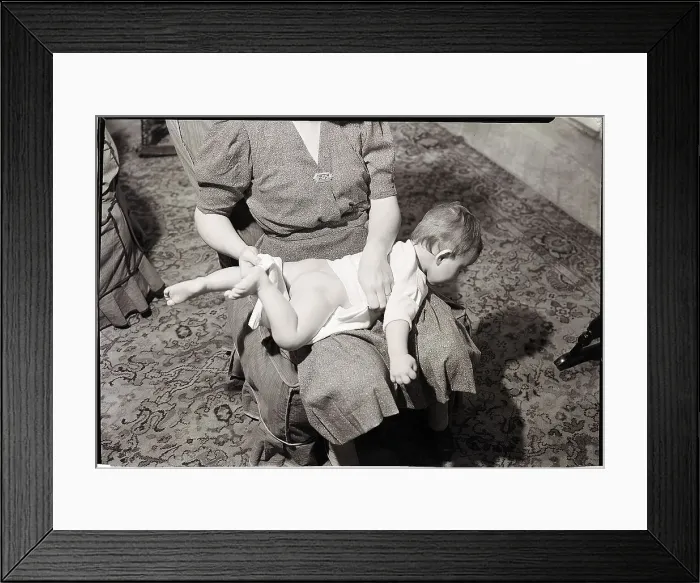Framed Print : Woman Changing Baby on Lap Framed Print : Woman Changing Baby on Lap