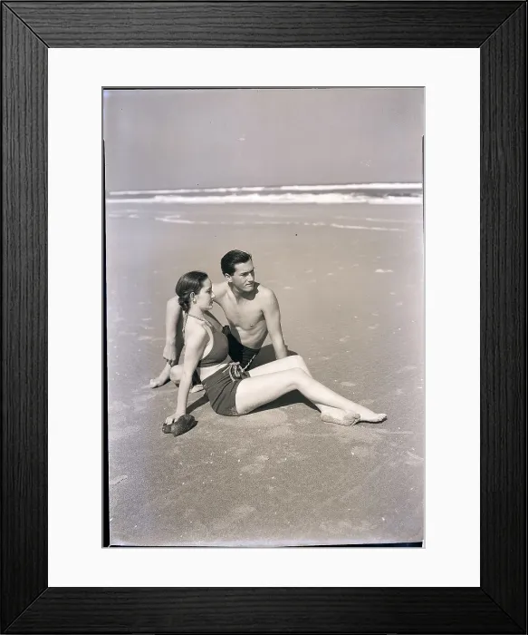 Framed Print : Young Couple Seated on Beach Framed Print : Young Couple Seated on Beach